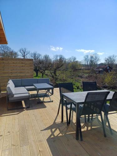 a patio with tables and chairs and a couch at Klinta sea view 2 in Köpingsvik