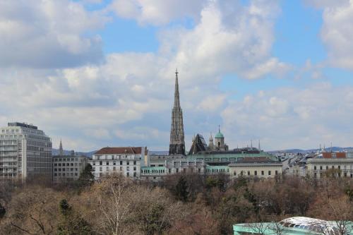 a view of a city with a spire and buildings at Hotel Goldene Spinne in Vienna