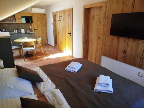 a bedroom with a bed with towels on it at Sklep Víno Strýček in Velké Bílovice