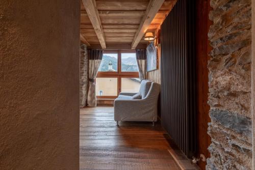 a living room with a chair and a window at Elva Apartments in Elva