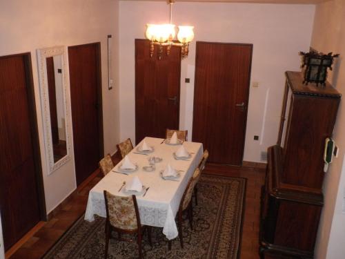 a dining room with a white table and chairs at Pension Arcadia Prague in Prague