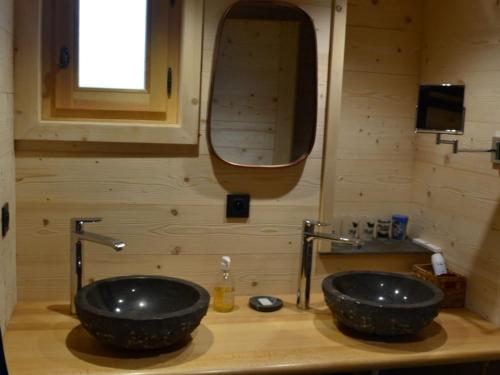 a bathroom with two black sinks and a mirror at Appartement Châtel, 4 pièces, 6 personnes - FR-1-676-54 in Châtel