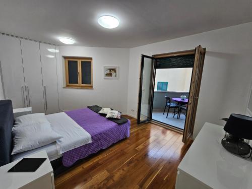 a bedroom with a bed and a sliding glass door at Sweet suite in Makarska