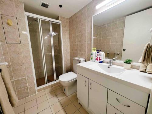 a bathroom with a toilet and a sink and a shower at Darling harbour & ICC & CBD & Chinatown & Spacious in Sydney