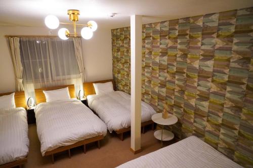 En eller flere senge i et værelse på Niwa House / Vacation STAY 2195