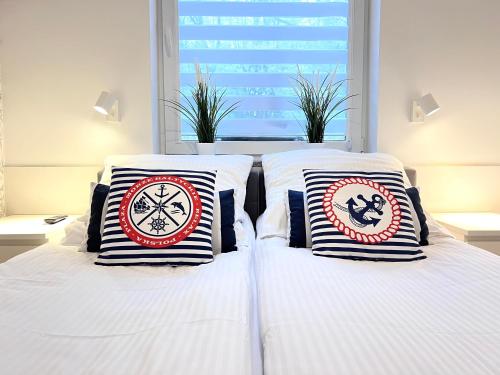two beds with pillows on them in a bedroom at Słoneczna Przystań-Apartamenty in Gdańsk