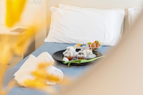 a plate of food on a bed with a pillow at Hotel Ristorante Montuori in Pimonte
