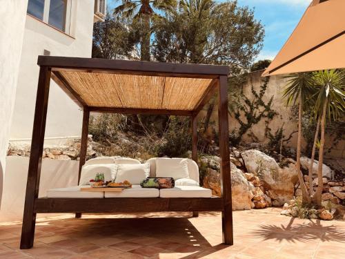 a wooden gazebo with chairs and a table at Ibiza Dream Villa Denia, Seaview, Pool, BBQ, Airco, Wifi in Denia