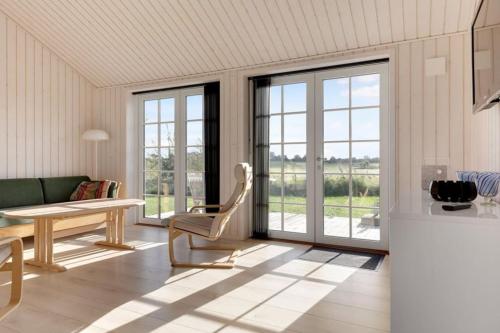 a living room with a couch and a table at Havnsø med udsigt in Føllenslev