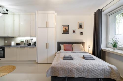 a bedroom with a large bed with two pillows on it at GA- Cozy Studio - City Center- Orła in Warsaw