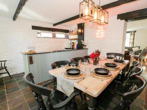 a dining room with a wooden table and chairs at Smithy House in Dumfries