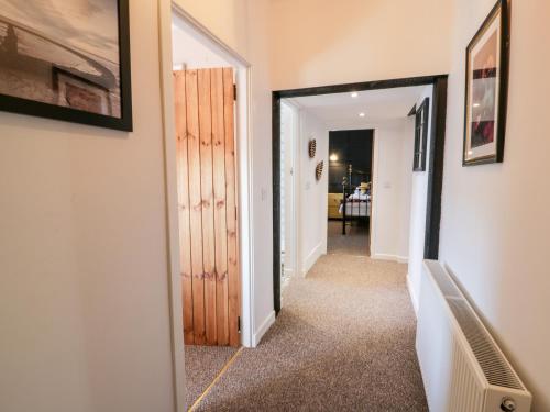 a hallway with a door leading into a room at Smithy House in Dumfries