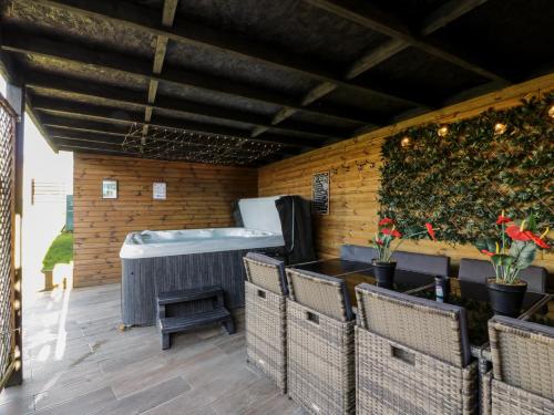 a bar with a bath tub on a patio at Smithy House in Dumfries