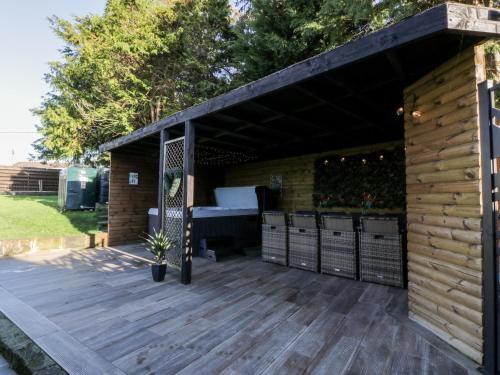 a wooden deck with a pergola at Smithy House in Dumfries