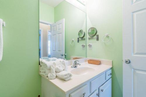 a bathroom with a sink and a mirror at Orange Beach Villas - Casa Bella in Orange Beach