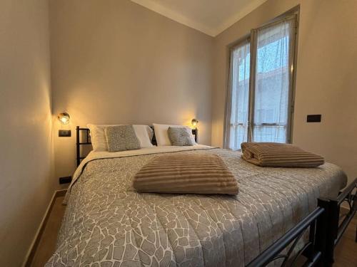 a bedroom with a large bed with two pillows on it at HappyHome Rivarolo 6 posti letto in Rivarolo Canavese