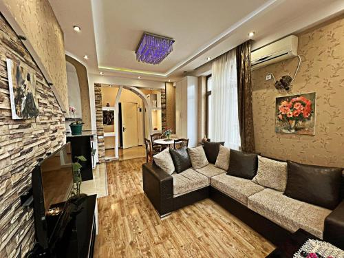 a living room with a couch and a fireplace at Cozy apartment in the city center Mtatsminda in Tbilisi City