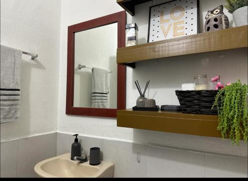 a bathroom with a sink and a mirror at Apartamento entero Rebeca house in Santa Ana