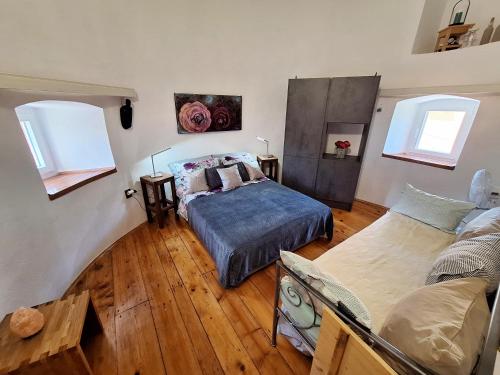 a bedroom with a bed and a couch at Old Mill in Rogoznica
