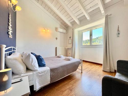 a bedroom with a bed and a large window at Villa Rubina Sidari with private pool by DadoVillas in Velonádes