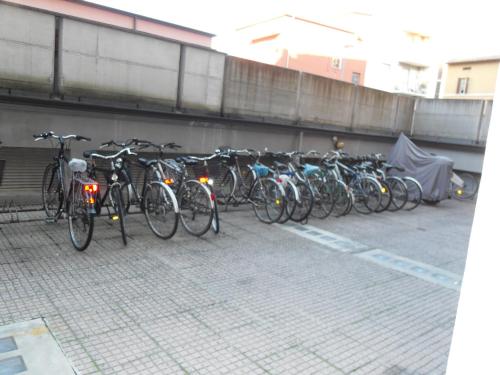 a row of bikes parked next to a wall at Europe Station Rooms in Parma
