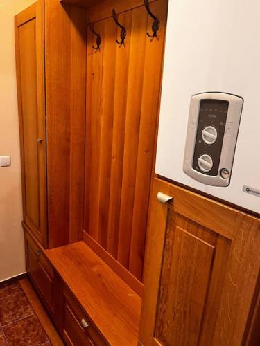 a wooden cabinet with a cell phone on top of it at Central Apartment - Book Now in Cluj-Napoca