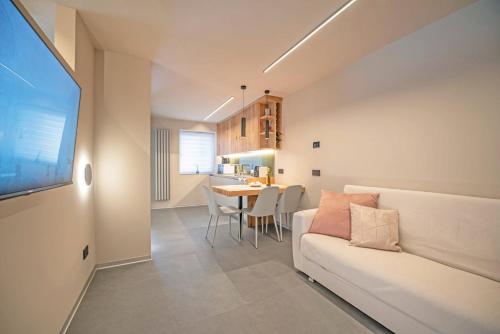 a living room with a white couch and a table at Dedde Home in Aosta