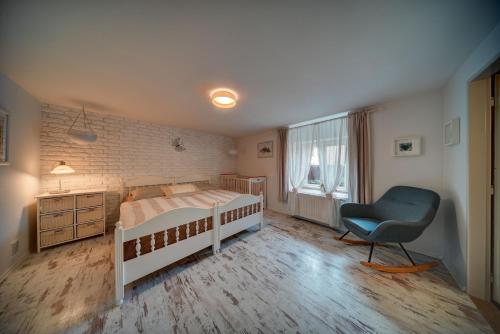 a bedroom with a bed and a desk and a chair at Chaloupka u potoka in Kutná Hora