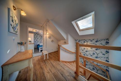 a room with a staircase and a window at Chaloupka u potoka in Kutná Hora