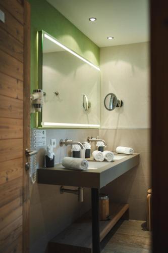 a bathroom with a sink and a mirror at Alpinhotel Berghaus spa in Tux