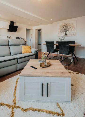 a living room with a couch and a table at Appartement T3 Hyper centre Saumur in Saumur