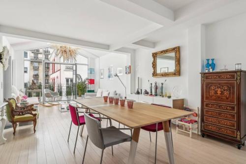 une salle à manger avec une table et des chaises en bois dans l'établissement Maison d'architecte Sacré Coeur, à Paris