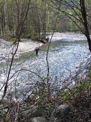 a person is walking through a stream of water at Acero Rosso in Malonno