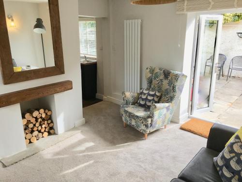 a living room with a chair and a fireplace at The Burrow in Wetherby