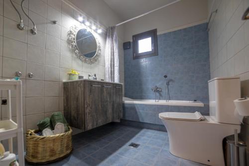 La salle de bains est pourvue d'une baignoire, de toilettes et d'un lavabo. dans l'établissement Meteοra Sunshine Apartment, à Kalambaka