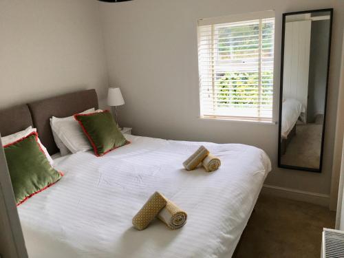 a bedroom with a bed with two logs on it at The Burrow in Wetherby