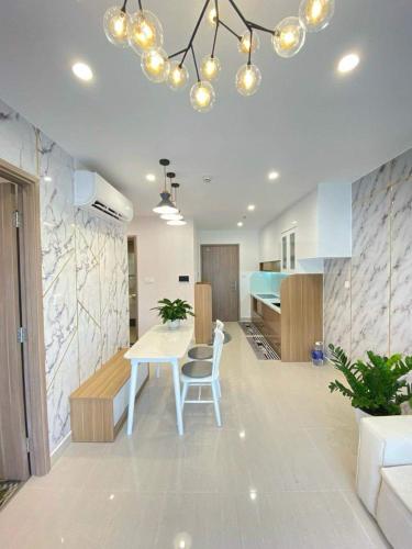 a kitchen and dining room with a table and a dining room at Căn hộ 2 Phòng Ngủ Vinhomes Grand Park, Thủ Đức city, Hồ Chí Minh city in Gò Công