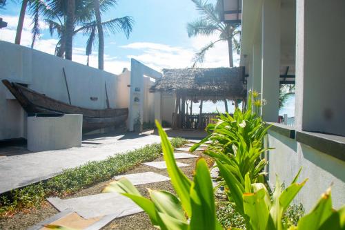 a building with palm trees in front of a building at Sailors' Bay in Hikkaduwa