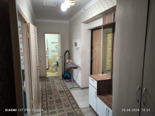 a bathroom with a sink and a mirror at Уютная квартира комфорт класса74 in Astana