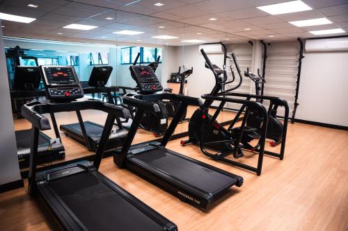 a gym with several treadmills and elliptical machines at Foz Plaza Hotel in Foz do Iguaçu