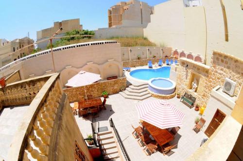 an overhead view of a patio with a swimming pool at 6 Bedroom Farmhouse with Large Private Pool in Żebbuġ