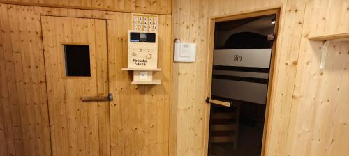 a wooden room with a door and a machine at Schlossberg in San Leonardo in Passiria