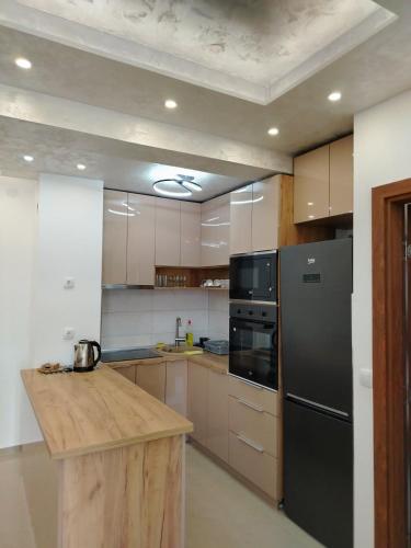 a kitchen with a black refrigerator and a counter at Apartman Branković Pirot-Zapadni Kej 58 in Pirot