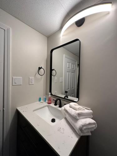 a bathroom with a sink and a large mirror at Green Harbor Hotel in Marshfield