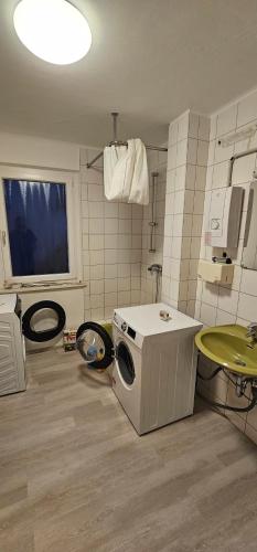 a kitchen with a washing machine in a room at Gasthaus Ochsen in Rottweil