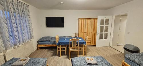 a living room with a blue table and a tv at Gasthaus Ochsen in Rottweil