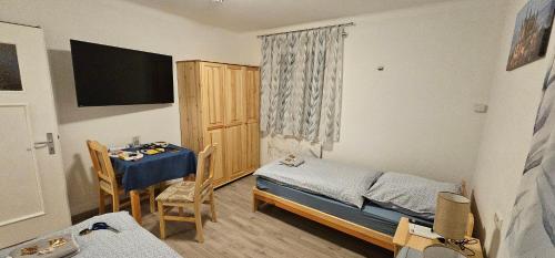 a small room with a bed and a table in it at Gasthaus Ochsen in Rottweil
