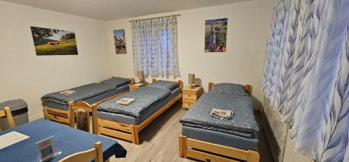 a hospital room with three beds and a table at Gasthaus Ochsen in Rottweil