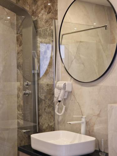 a bathroom with a sink and a mirror at Apartmani Maksa in Stanovo