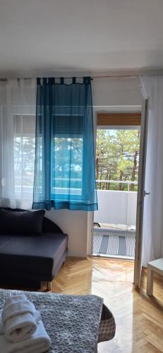 a living room with a couch and a window at Aurora with the view in Rijeka